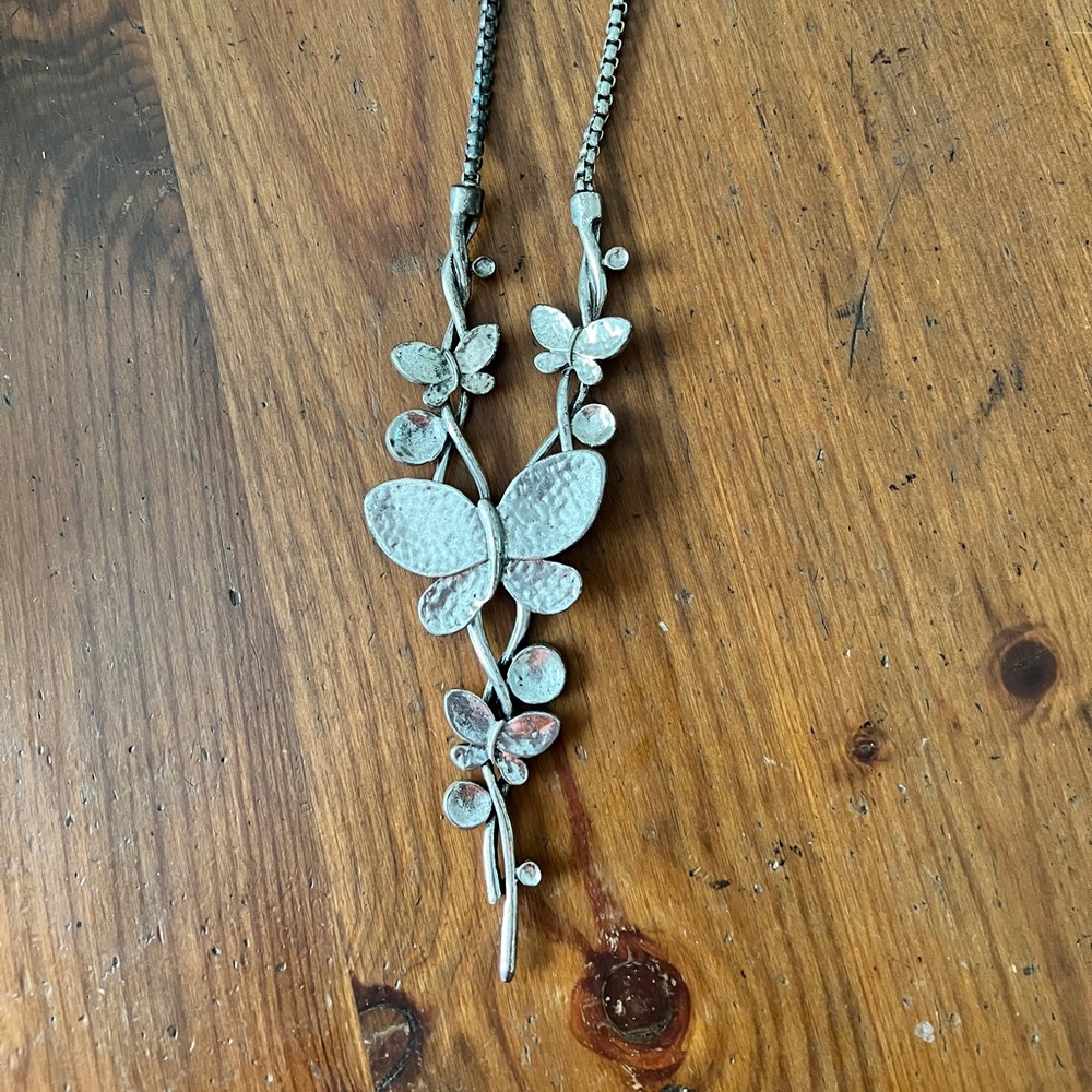 Silver butterfly necklace, unique and off brand.